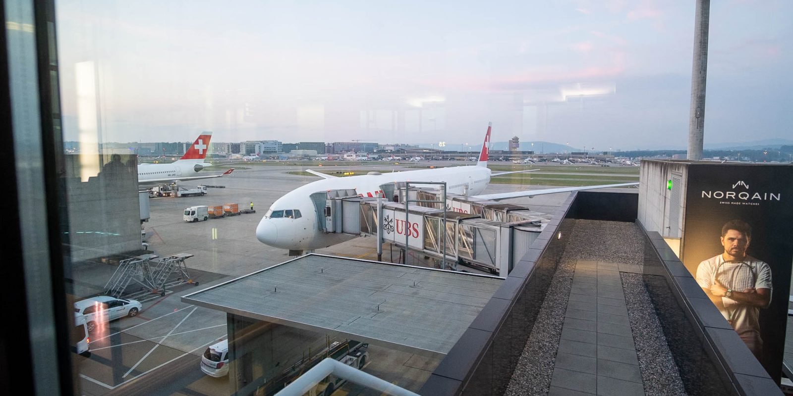 SWISS B777 300 ER plane docked by the air bridge.