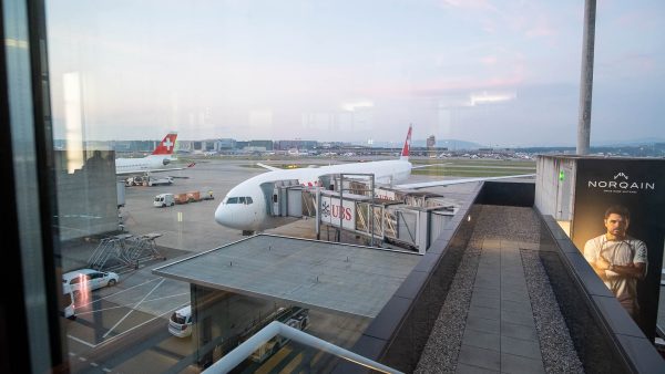 SWISS B777 300 ER plane docked by the air bridge.