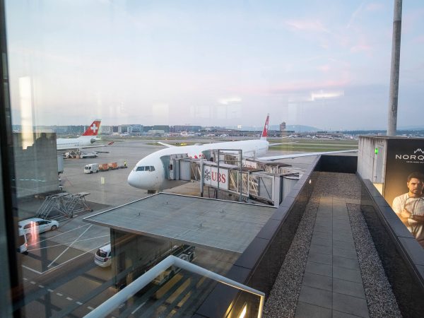 SWISS B777 300 ER plane docked by the air bridge.