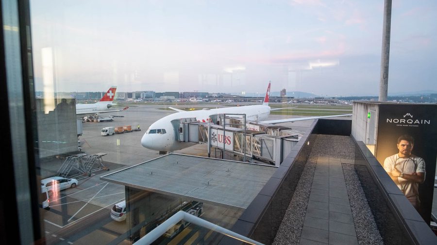 SWISS B777 300 ER plane docked by the air bridge.