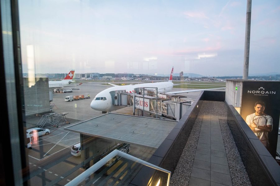 SWISS B777 300 ER plane docked by the air bridge.